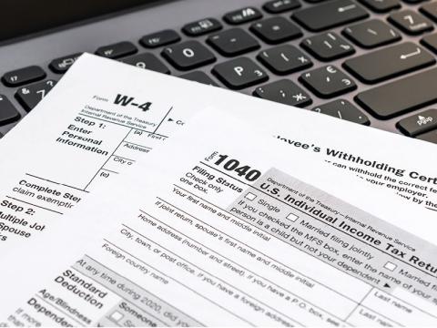 IMAGE: Tax forms resting on a keyboard