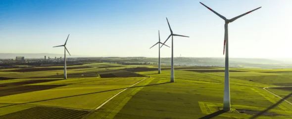 Several windmills on a green landscape.